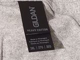 the back of a gray sweater with a black label on it