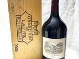a bottle of wine sitting next to a wooden box
