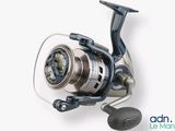 a close up of a spinning reel on a white surface