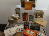 many different types of tins on display on a table
