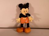 mickey mouse plush toy sitting on top of a white surface