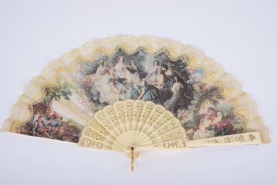 a fan with a painting on it sitting on a table