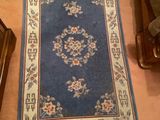 a rug on the floor next to a person ' s feet