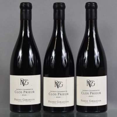 three bottles of wine are lined up on a table