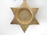 a gold ring on top of a star shaped ornament