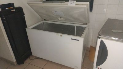 a refrigerator and a freezer in a small room
