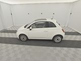 a picture of a small white car parked in a garage