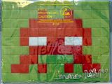 a green and red bag with a picture of a red robot on it