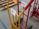 a hand truck with a sign on it in a warehouse