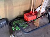 a broom that is sitting on the floor next to some tools