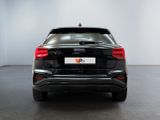 the rear end of a black car in a white room