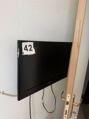 a flat screen tv mounted on the wall next to a door