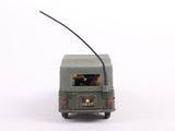 a toy army vehicle with a long antenna on the back of it