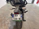 a motorcycle parked in a garage with a license plate on the back of it