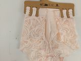 pink panties with white lace on a hanger on a white wall