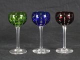 three wine glasses are lined up in a row on a black background