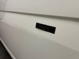 a close up of a white car with a sticker on it ' s side