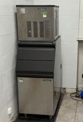 a picture of a commercial ice machine in a public bathroom
