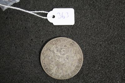 une pièce d'argent à laquelle est attachée une étiquette indiquant son prix