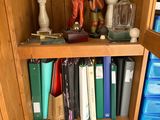 a book shelf with a lot of books and vases on it