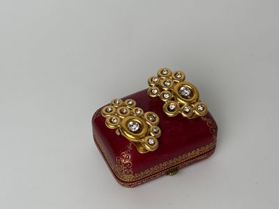 a small red box with some gold decorations on it