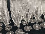 a lot of empty wine glasses on a black table