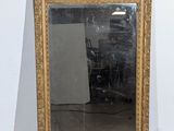 a mirror that is sitting on the floor in a room