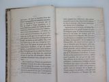 an open book with writing on it sitting on top of a table