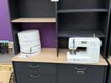 a sewing machine sitting on top of a cabinet in a room