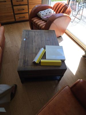 a coffee table with a book on top of it in a living room