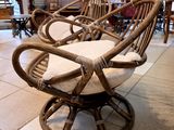 a wicker chair that is sitting in the middle of a room