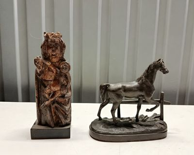 a statue of a woman and a horse on a table