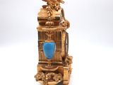 a gold clock with a blue stone in the middle of it