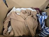 a cardboard box filled with clothes and clothing items