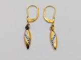 a pair of gold and silver earrings on a white background