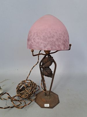 a lamp that has a pink shade on top of it