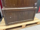 a wooden cabinet on a pallet in a room