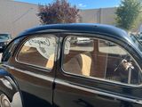 a small black car with a sign on the side of it