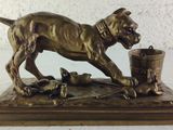bronze statue of a dog with a bucket and mice