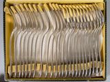 a lot of forks in a box on the table