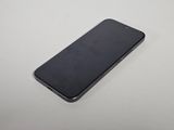 a close up of a cell phone on a white surface