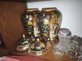 many vases that are on a shelf in the room