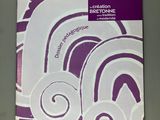 purple and white brochure with white swirls on it on a table