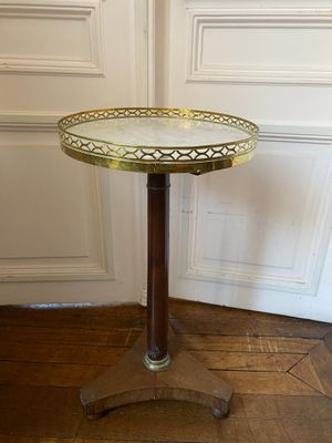 a small table with a glass top sitting on a wooden floor