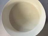 a white bowl that is sitting on a table