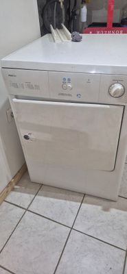 a white washer and dryer in a small room