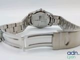 a watch that is sitting on a white surface