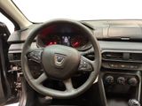 the interior of a car with a steering wheel and dashboard controls