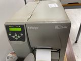 a machine that is sitting on a table with a roll of paper