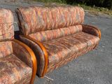 two couches that are sitting on the pavement